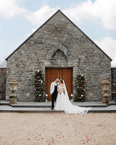 Bridge & Groom share a kiss outside irish wedding venue