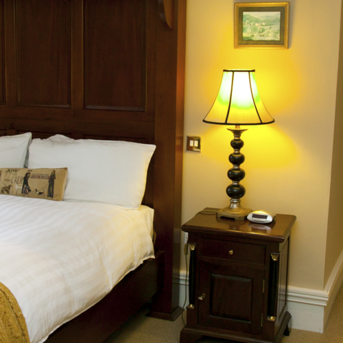 Bedside table and bed in hotel suite in kerry