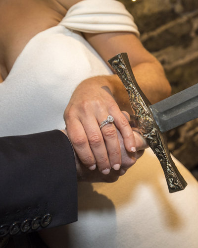 Bride and groom hold sword at irish castle wedding