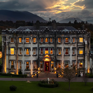 Ballyseede castle hotel at dusk exterior view with lights 