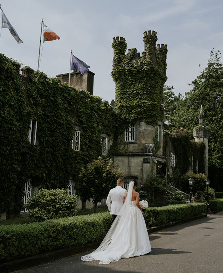 Newlyweds walking through the ballyseede country estate gardens