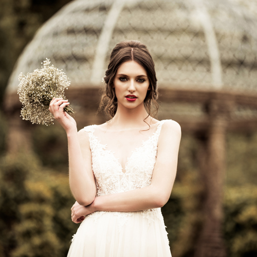 Bride holding bouquet in country estate garden at ballyseede hotel