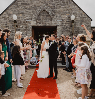 Guests celebrate as couple kiss on their wedding day