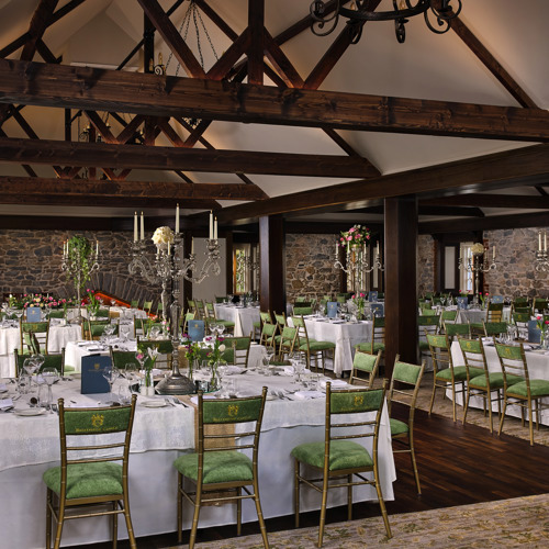 Hotel wedding reception hall on country estate with high ceilings and timber beams